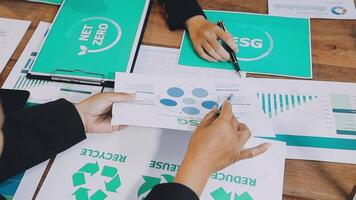 People working on papers with green and red recycling symbols video