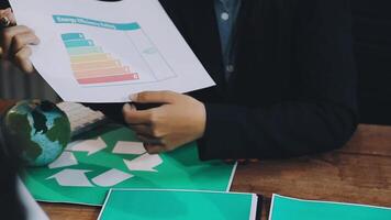 A woman is holding a paper with a graph on it video