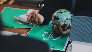 A person holding a green globe on a table video