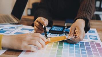 Two people working on a design project with color swatches video