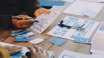 A person is working on a design project with papers and other items video