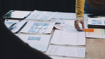A person is working on a project with papers and other items video