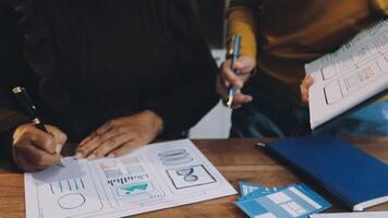 Two people working on a project at a table video