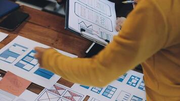 A person is looking at a design document on a table video