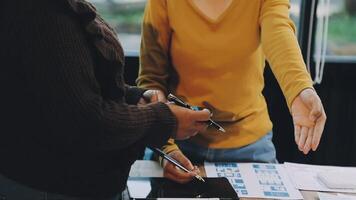 Two women shaking hands at a table video