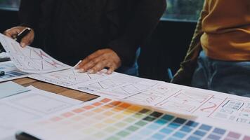 A man and woman are working on a design project video