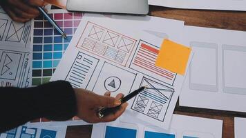 A person is working on a design project with a pen and paper video