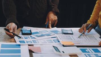 Two people working on a project with paper and pens video