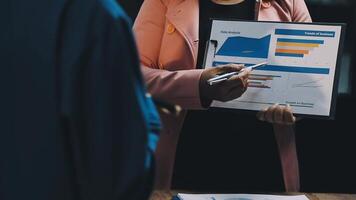 A woman is holding a clipboard with a graph on it video