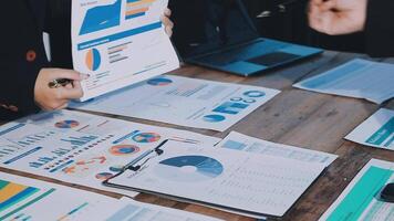 Business people working on papers with graphs and charts video