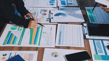 Business people working on graphs and papers video
