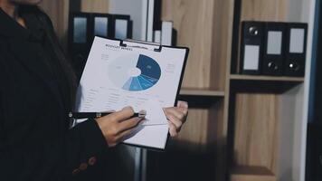 A person holding a clipboard with a pie chart on it video