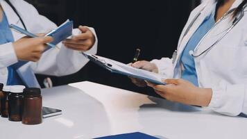 Two doctors are talking to each other at a table video