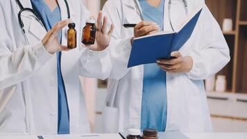 Two doctors holding bottles and a notebook video