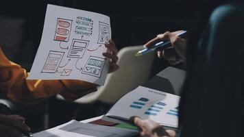 Two people are holding papers with diagrams on them video