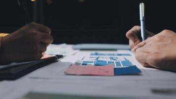 Two people working on a project with blueprints video