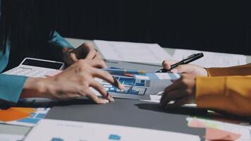 Two people working on a project at a table video