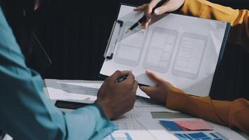 Two people working on a project with a piece of paper video