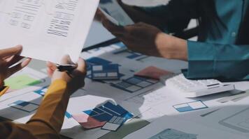 Two people working on a project with papers and blueprints video