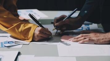 Two people working on a project at a table video