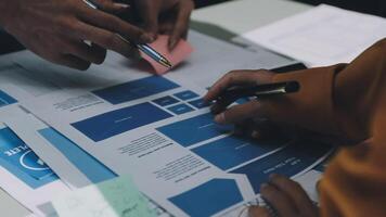 A group of people working on a project with blue papers video