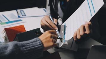 A person is holding a pen and paper while another person is writing on a piece of paper video