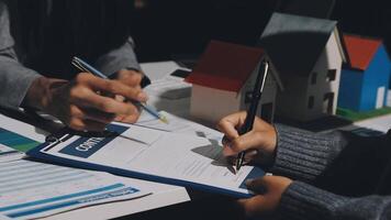 A real estate agent is writing a contract on a clipboard video