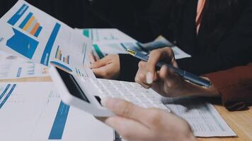 Business people using calculator and papers to make calculations video