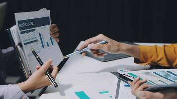 Business people working on paperwork at a desk video