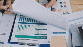A person is looking at a financial document on a desk video