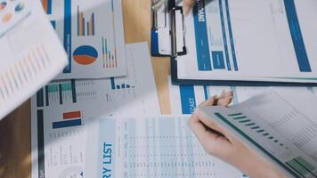 A person is looking at a table with papers and a pen video
