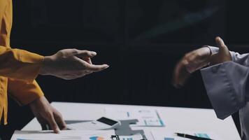 Two people shaking hands at a table with papers video