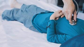 A child lying on a bed with a stethoscope video