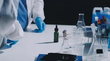 A person in a lab coat is working on a table video