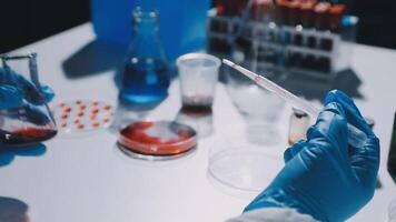 A person in a lab coat is holding a test tube video
