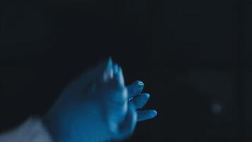 A person in a blue glove is holding something video