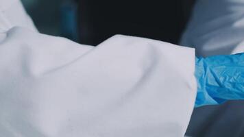 A person in a lab coat is holding a small piece of paper video