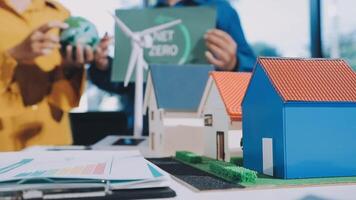 A man and woman are holding a model of a house video