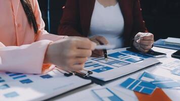 Two people working on a project with blue and red papers video