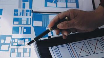 A person is using a tablet to design a website video