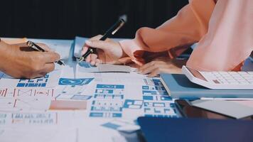 Two people working on a project with blueprints and papers video