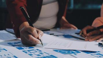 A person is writing on a piece of paper with blue and white papers video