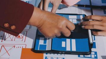 Two people working on a tablet with blue and red paper video