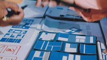 A man and woman are working on a project with blue and white paper video