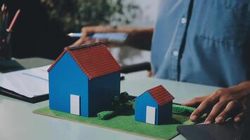 A person is working on a model of a house video