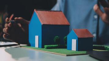 A person is working on a model of a house video