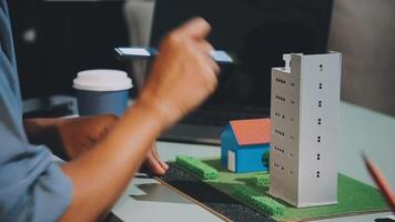 A person is working on a model of a building video