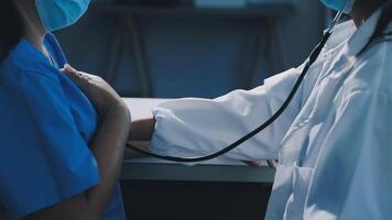 A doctor is checking the heart rate of a patient video