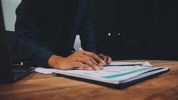 A person is writing on a piece of paper while sitting at a desk video