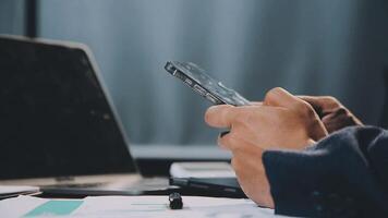 A person is using a cell phone while sitting at a desk video